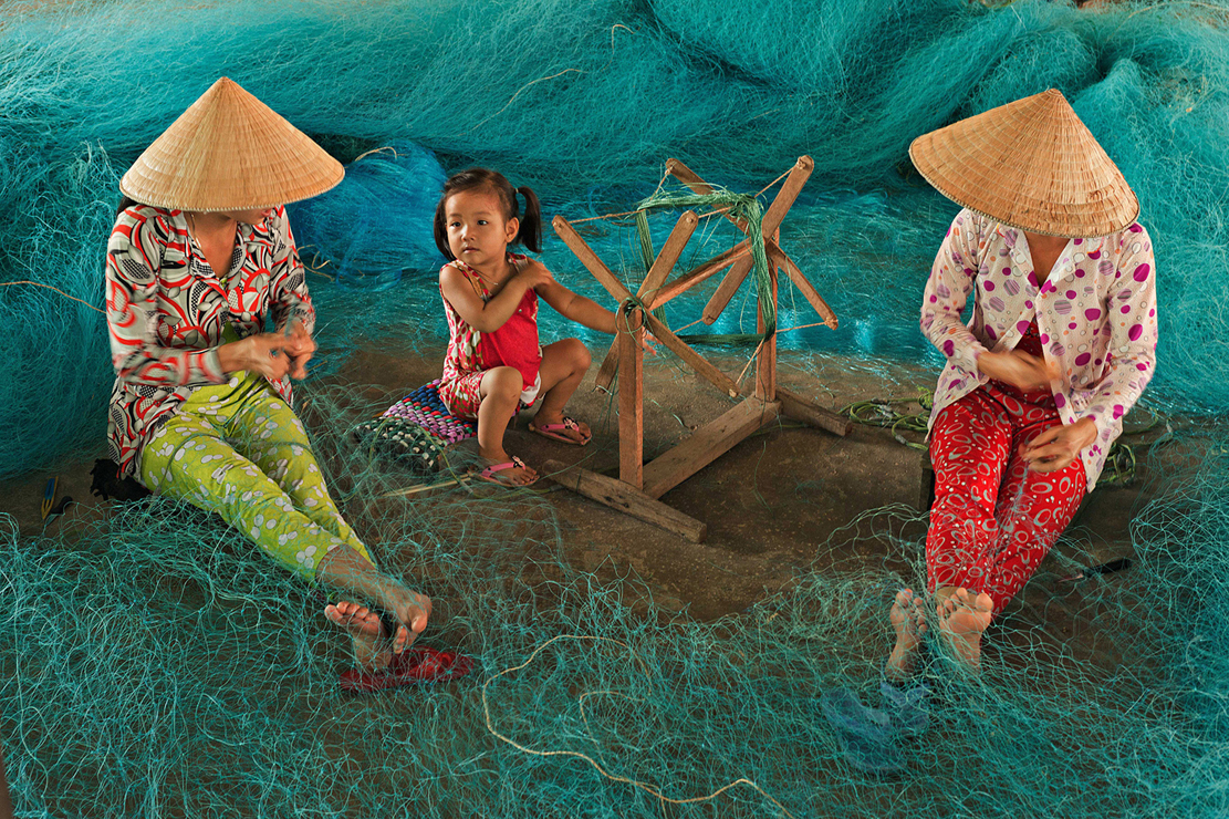 COLOR #2 THANH LAM Title Repairing Nets While Watching Child.jpg