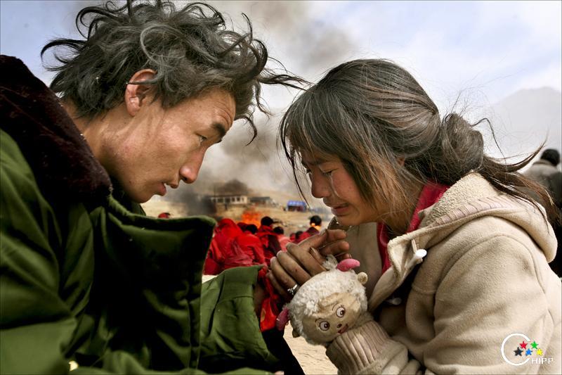 2010年4月17日，在结古镇扎西大通路西侧的山坡上，20岁的贡嘎正在安慰哭泣的妻子卓嘎，.jpg